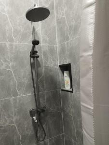 a shower with a lamp in a bathroom at Seven Day in Bishkek