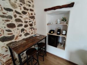 a room with a wooden table and two stools at Villa Bianca in Orosei