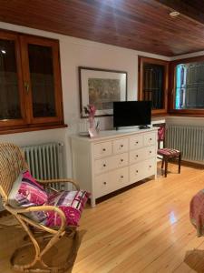 a living room with a television and a dresser at Villa 225 in Bracciano