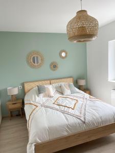 a bedroom with a bed and two mirrors on the wall at Villa de standing en Champagne in Fresnes-lès-Reims +40 photos