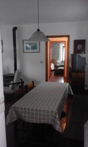 a living room with a table with a checkered blanket at Casa Ramonda in Neive