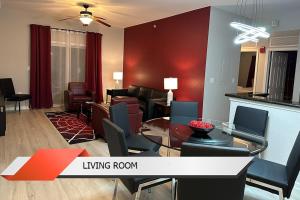 a living room with a table and a living room at Spider-Man-themed condo near Disney, Sea World, Universal and OCCC with pool, spa, restaurants, shuttle, private balcony, and view of fireworks shows in Orlando