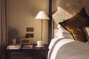 a bedroom with a bed and a table with a lamp at No 42 by GuestHouse, Margate in Margate