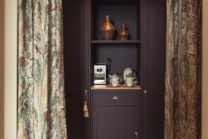 a room with a shelf with a coffee maker on it at No 42 by GuestHouse, Margate in Margate