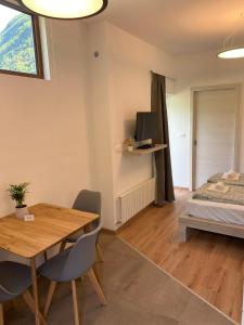 Cette chambre comprend une table à manger et un lit. dans l'établissement Apartment Nona Polda, à Kobarid