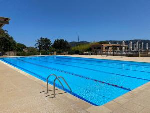 a large swimming pool with blue water at Appartement Marina di Fiori by Intendance Excellency in Porto-Vecchio +28 photos
