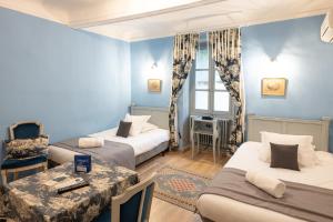 a blue room with two beds and a table at Château de Servanes in Mouriès +31 photos