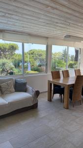 a living room with a couch and a table at Hotel Villa Maya in Saint-Tropez
