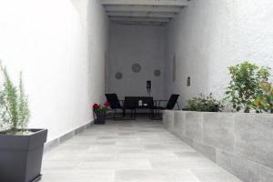 a patio with a table and potted plants at Lorien City Center Apartments in Ioannina