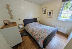 a small bedroom with a bed and a window at Lovely home by Glomma river! in Vidnes