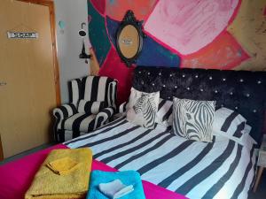 a bedroom with a bed with zebra pillows at Sailaway in Carbis Bay