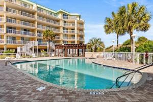 a swimming pool in front of a large building at Beachfront Oasis at Litchfield By the Sea: 3 Bdrm in Pawleys Island