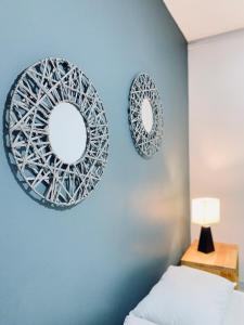 two mirrors on a blue wall next to a bed at Casa compartida ''Central Hostel'' in Medellín