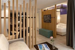 a living room with a couch and a table at Royal Antibes - Luxury Hotel, Résidence, Beach & Spa in Antibes