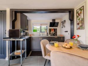 a kitchen and dining room with a table and chairs at 1 Bed in Sissinghurst 88466 