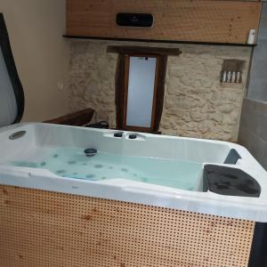 a large bath tub in a room at GÎTE de DRAGOUX in Bas Bouvante