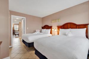 a hotel room with two beds and a hallway at Ocean View 1BR Condo in Myrtle Beach