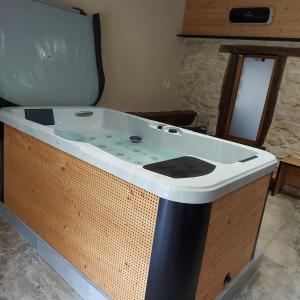 a jacuzzi tub sitting in a room at GÎTE de DRAGOUX in Bas Bouvante