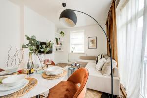 a living room with a table and a couch at BRICK LANE APARTMENT in London