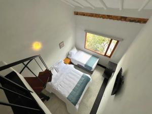 an overhead view of a bedroom with two beds at Hotel Antiguo Macondo in Villa de Leyva