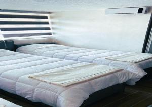 two beds sitting next to each other in a bedroom at kirakoupolis House & Restaurant in Kerak