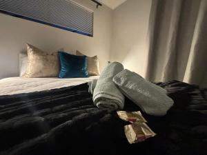 a bed with towels on it in a bedroom at Tyger Valley Villa in Durbanville