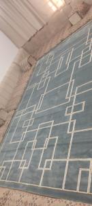 a blue rug with white patterns on a ceiling at شاليه تريك in Buraydah