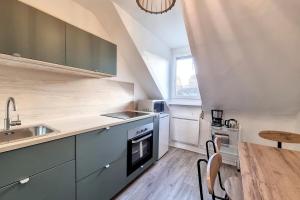 a kitchen with a sink and a stove top oven at Cosy Rent Strasbourg saint Florent proche Gare in Strasbourg