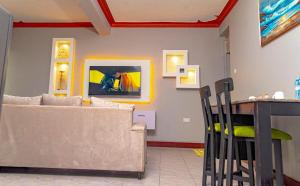 a living room with a couch and a table at Beautiful 2-Bed Apartment in Kampala in Jinja