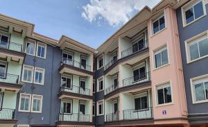 an apartment building with balconies on the side of it at Beautiful 2-Bed Apartment in Kampala in Jinja