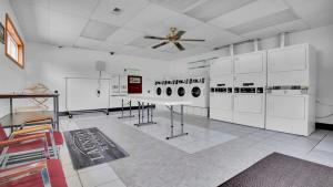 a room with white appliances and a ceiling fan at Rustic Cabin in Lake Monroe in Bloomington