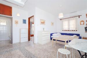 a white room with a bed and a table at Panagiotis Beach House Fourka 1 bedroom/5 guests in Skála Foúrkas