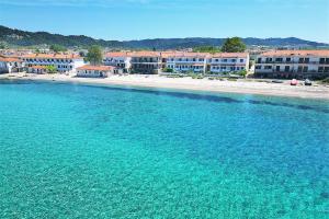 a large body of water with buildings in the background at Panagiotis Beach House Fourka 1 bedroom/5 guests in Skála Foúrkas