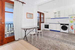 a kitchen with a table and stools in a room at Panagiotis Beach House Fourka 1 bedroom/5 guests in Skála Foúrkas +6 photos