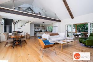a living room with a couch and a table at Beautiful Custom Lake House in Holland