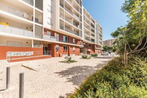 an empty street in front of a building at Marina Apartment close to beach & city in Portimão