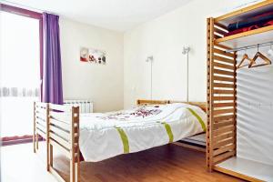 a bedroom with a bed and a bunk bed at Maison de 2 chambres avec jardin clos et wifi a La Chapelle Geneste in La Chapelle-Geneste