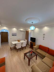 a living room with a couch and a table at ML Apartment Saranda in Sarandë +11 photos