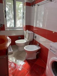 a bathroom with a toilet and a sink in it at ML Apartment Saranda in Sarandë