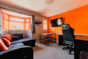 a living room with a couch and a desk at Hullidays 3 bed House Hull West Calvert in Hull