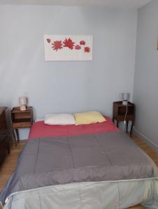 a bed in a bedroom with two night stands and two tables at Miloute à la Montagne in Bagnères-de-Bigorre