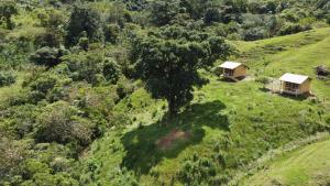an aerial view of two cottages on a hill at Camelia Hostel in San Carlos