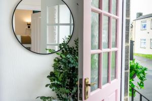a mirror hanging on a wall next to a door at Northern Hideaways, Castle Hill View in Bellingham +33 photos