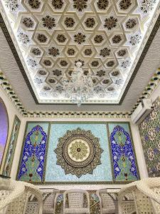 a room with a ceiling with blue and white tiles at Hotel Khalid in Bukhara