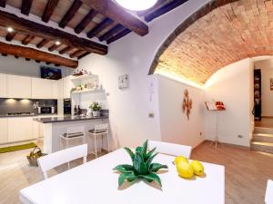 a kitchen and dining room with a white table and chairs at Siena Podere Rural Chic W Private Garden & Parking in Siena