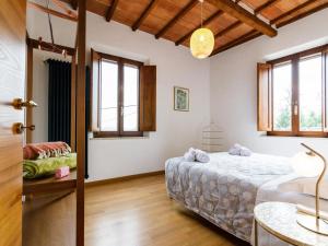 a bedroom with a bed and a table and windows at Siena Podere Rural Chic W Private Garden & Parking in Siena +56 photos