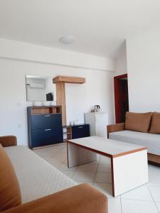 a living room with a couch and a table at Amarildo Hotel in Himare