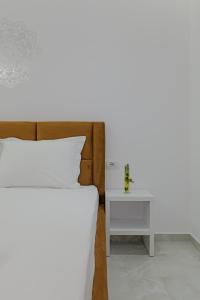 a bedroom with a bed and a side table at Vila Sofia in Ksamil