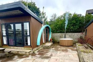 a small building with a fountain in a courtyard at Elletson Park in Preston