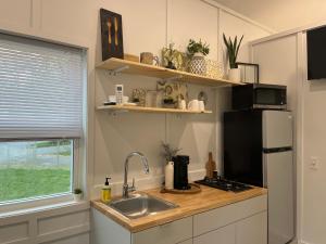 a kitchen with a sink and a refrigerator at The Overlook Tiny Home in Elizabethtown